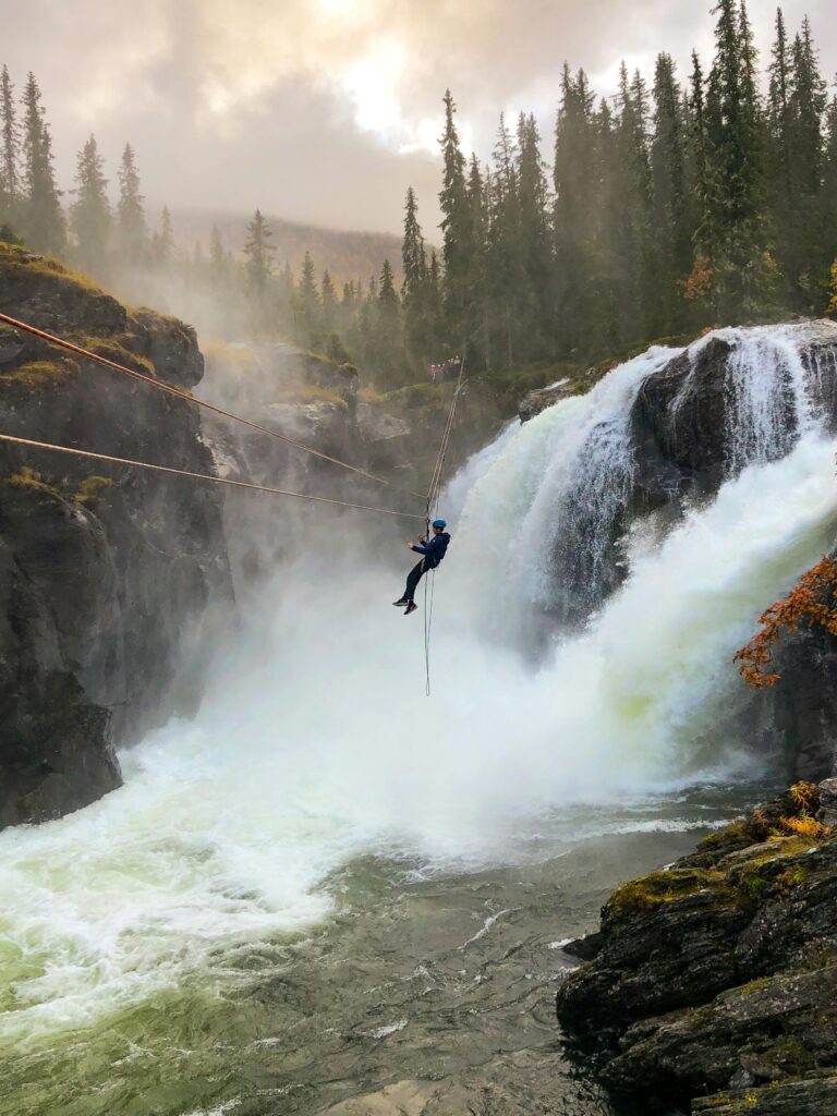 Man in Black Clothing on a Zipline